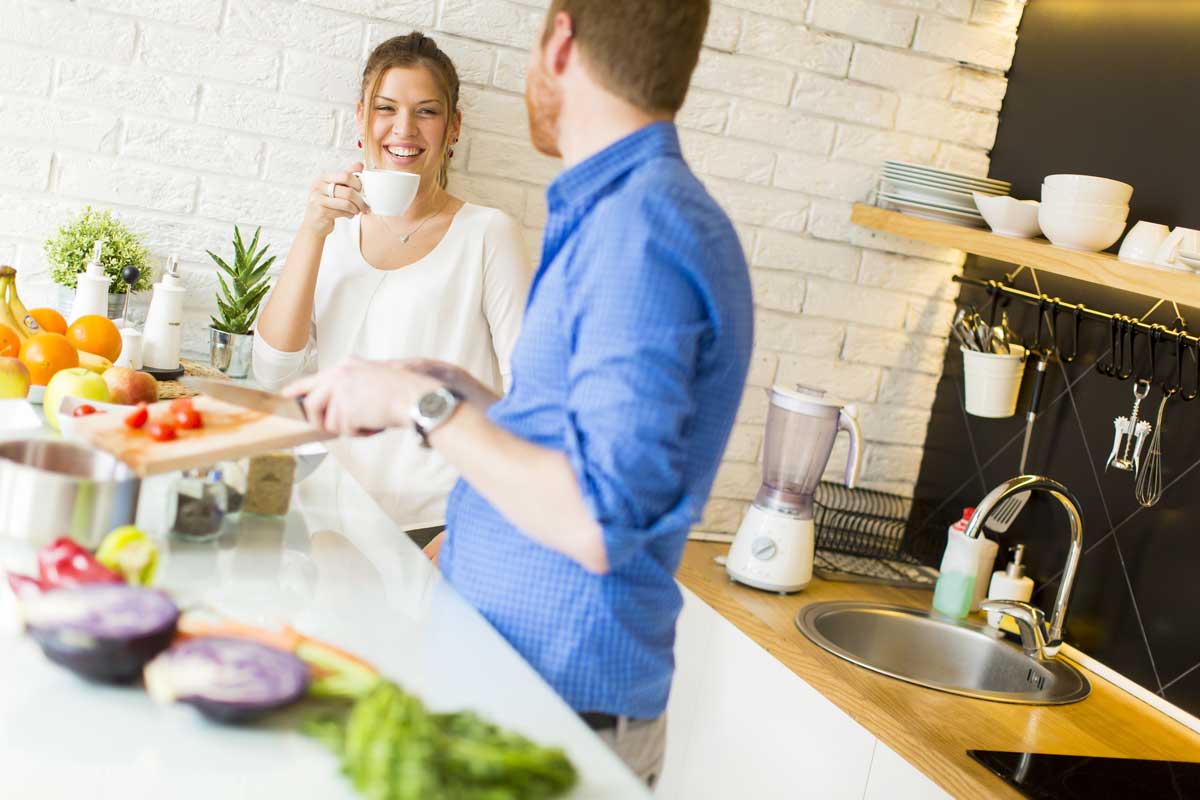 Couple laughing in kitchen lifestyle photo